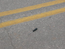 black hand tool in road