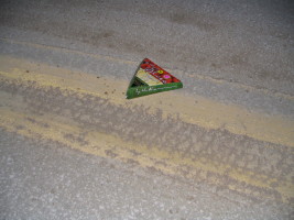 pizza slice box in road