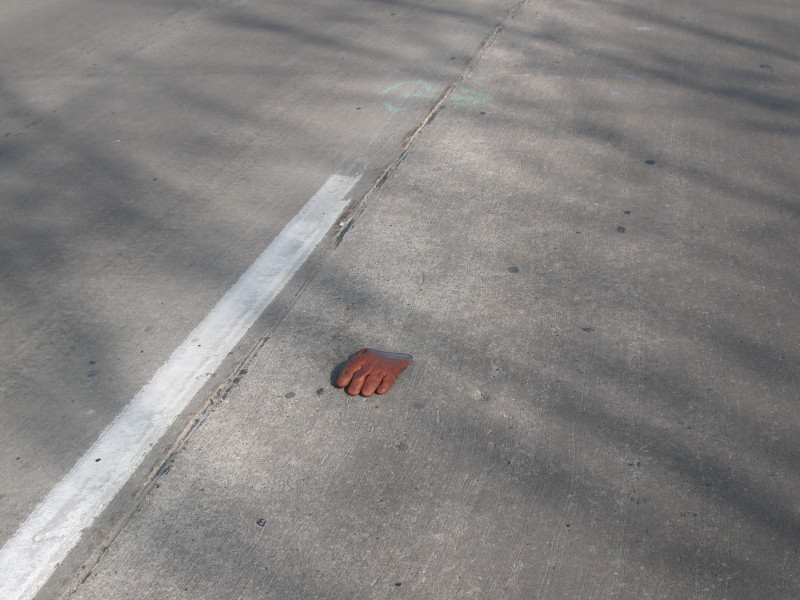 red rubber glove in road