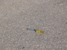 yellow screwdriver in road