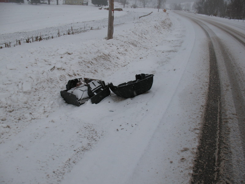 broken TV in road