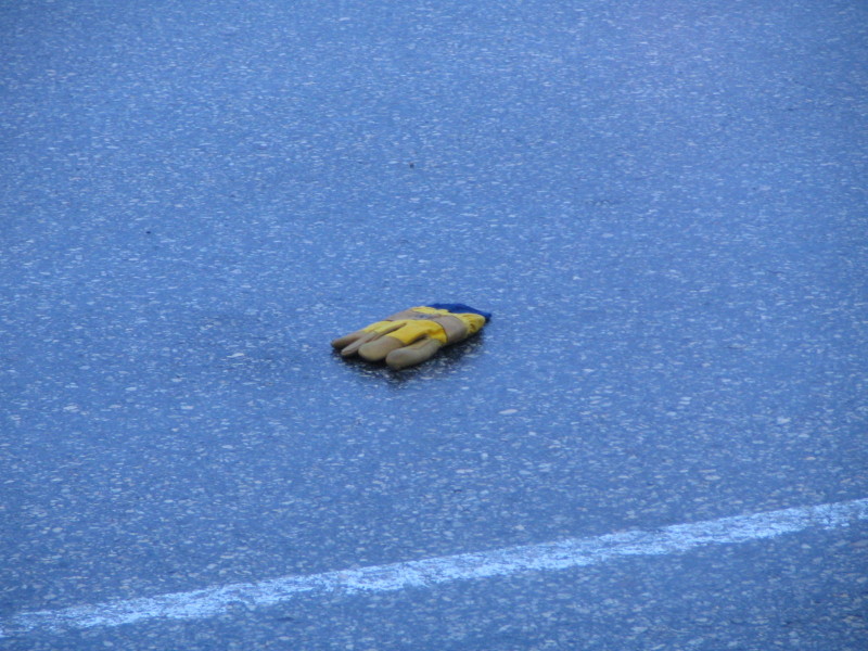 yellow work glove in the road